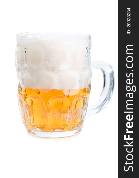Half-full glass of beer isolated on a white background