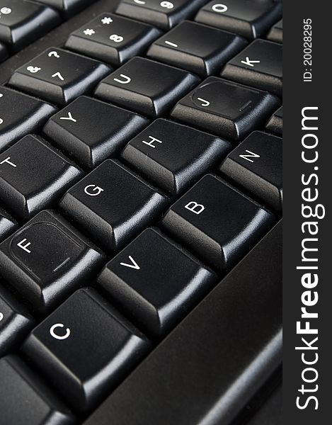 Black computer keyboard closeup on a background