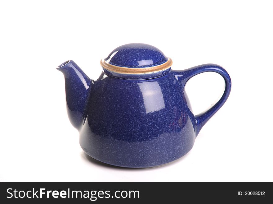 Photograph of a blue teapot shot in studio against a white background