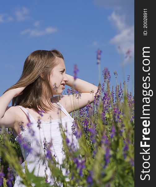 Young girl looking at the sky walking in a meadow. Young girl looking at the sky walking in a meadow