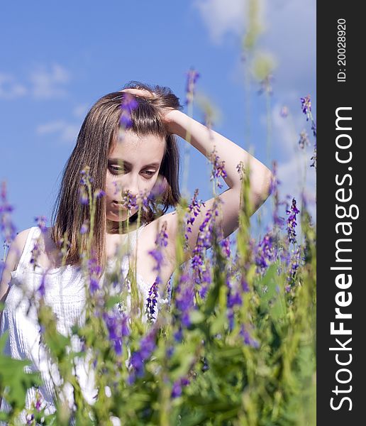 Young dreaming girl walking in a meadow