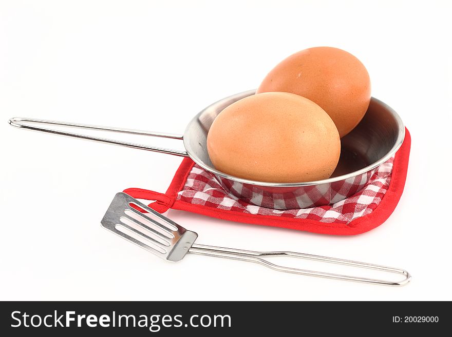 Frying pan with eggs on a white background