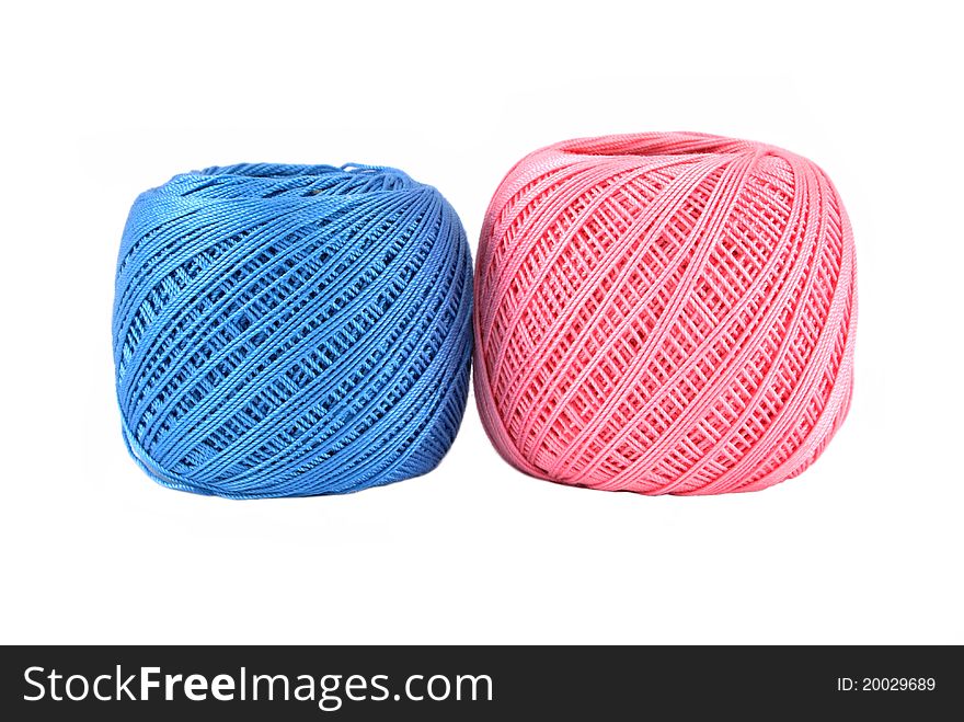 Blue and bigger pink thread ball isolated. Blue and bigger pink thread ball isolated