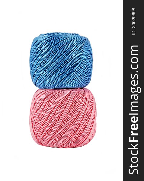 Blue over bigger pink thread ball isolated. Blue over bigger pink thread ball isolated