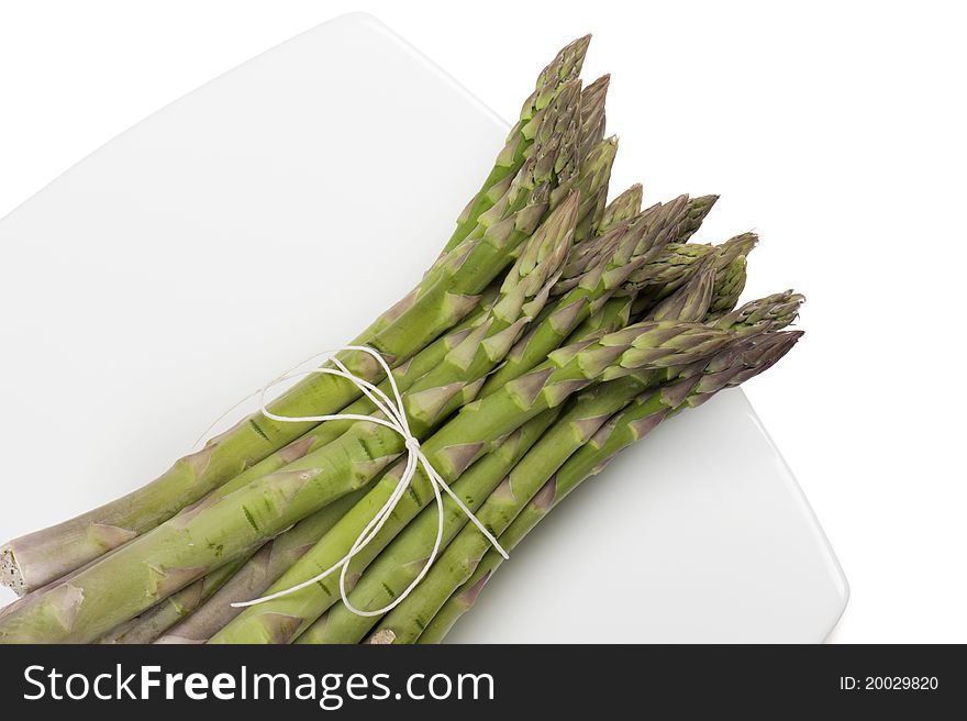 Asparagus on plate, on white background