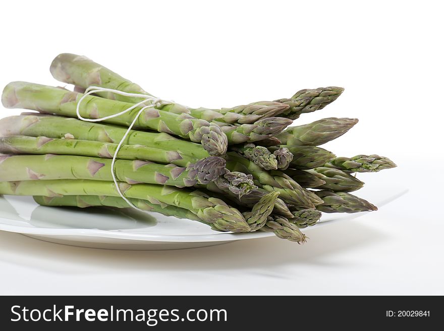 Asparagus on plate, on white background