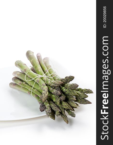 Asparagus on plate, on white background