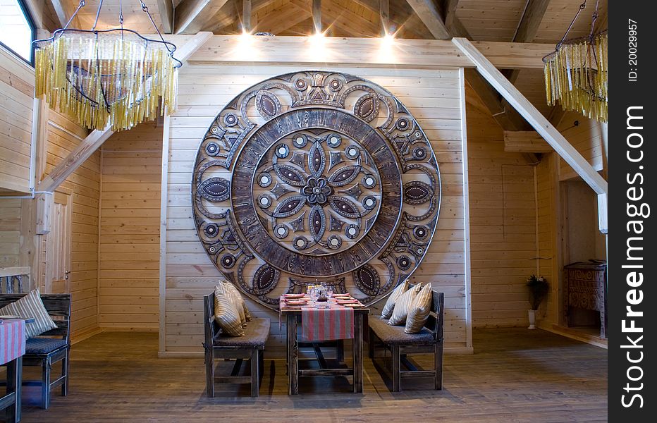 Interior of the restaurant in ethnographic style with the dinner table