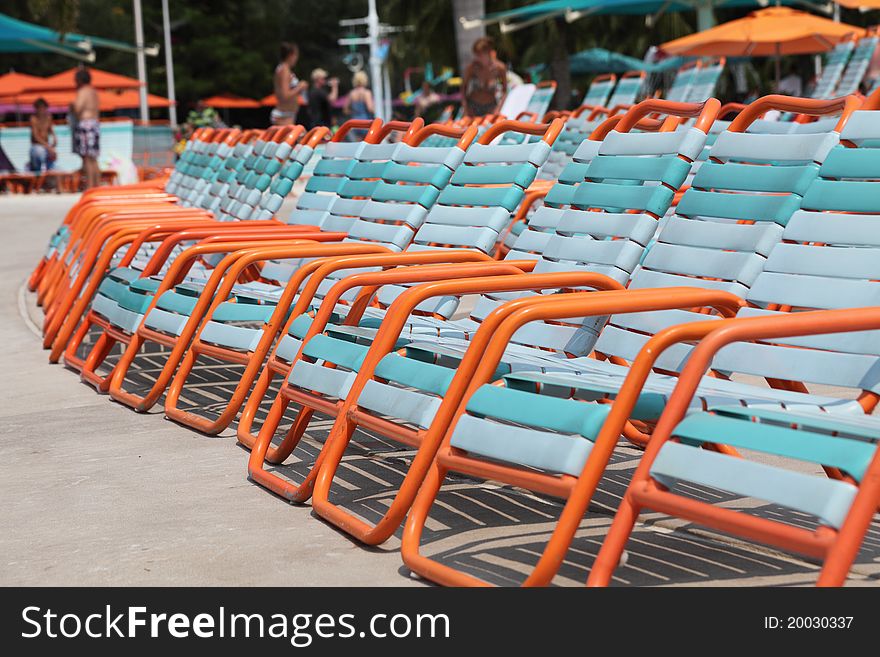 Resort sun lounger chairs in tropical sunshine