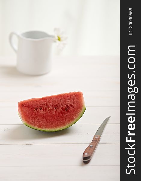 Watermelon on a white wood table in the kitchen. Watermelon on a white wood table in the kitchen