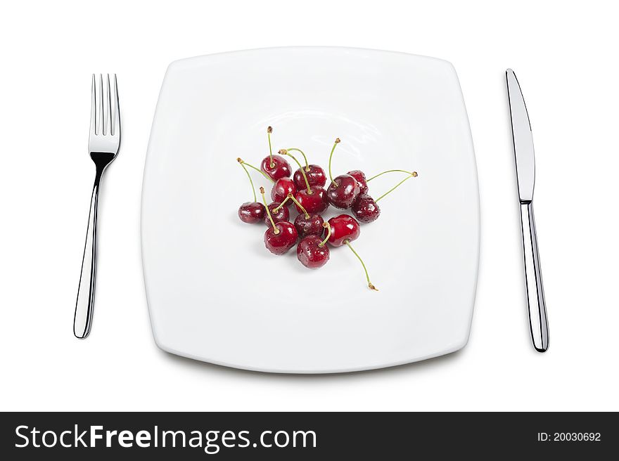 Table set with cherries, isolated on white