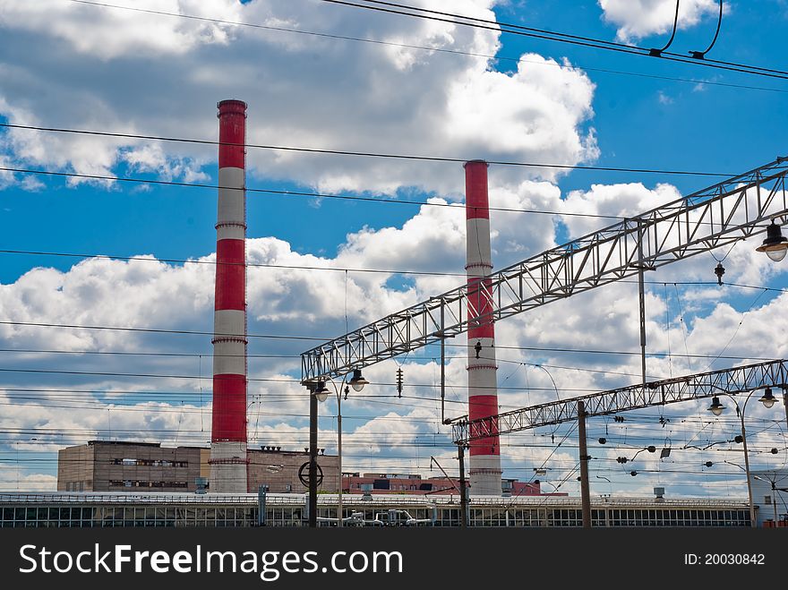 Steam power plant with two pipes against the background of cloudy sky