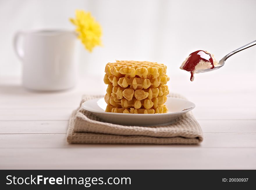 Belgian waffles and ice cream in the dish on a white table. Belgian waffles and ice cream in the dish on a white table