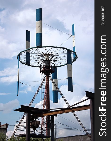 Harmless installation for reception of the electric power with the help of a wind on a background of the blue sky with clouds