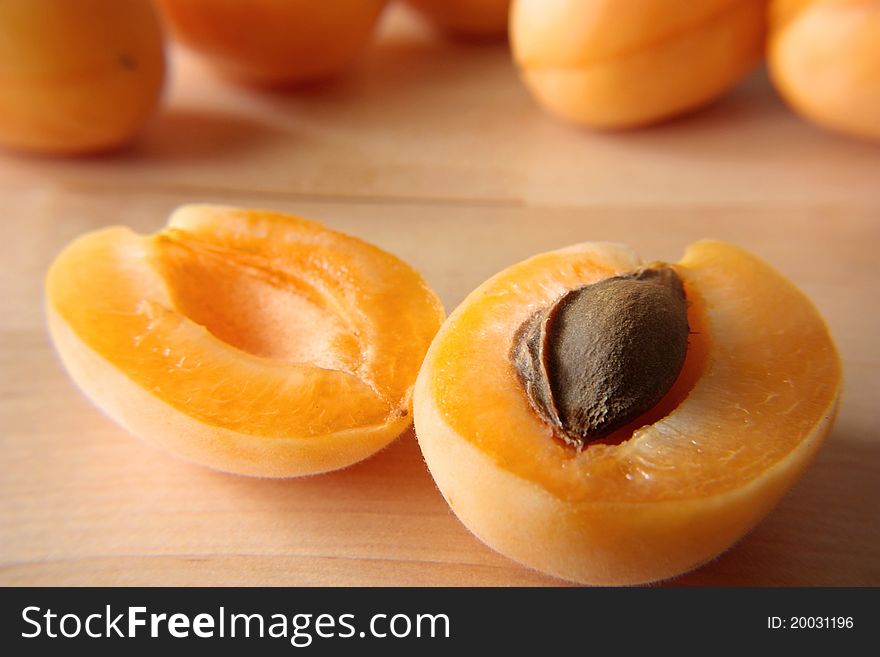 Two half of ripe tasty apricot lay on a table