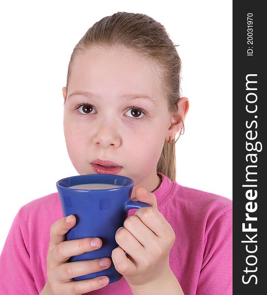 The girl drinks milk from a blue cup