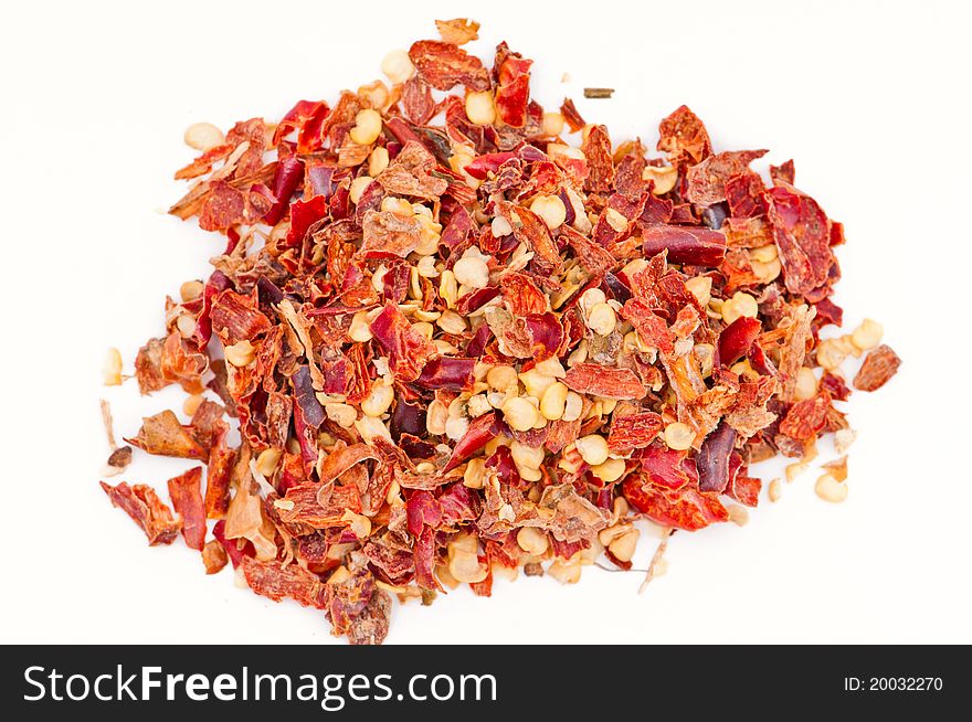 Pile of Hot Red Chilli Chillies pepper, dried and crushed.  Shallow DOF, isolated on white