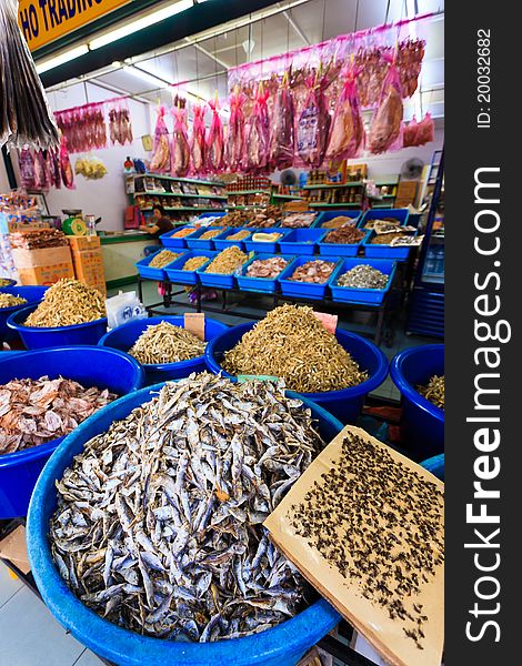 Plastic basket with lots of dried fish. Plastic basket with lots of dried fish