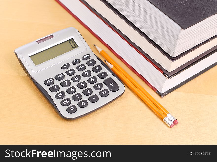 Calculator with Textbooks And Pencils