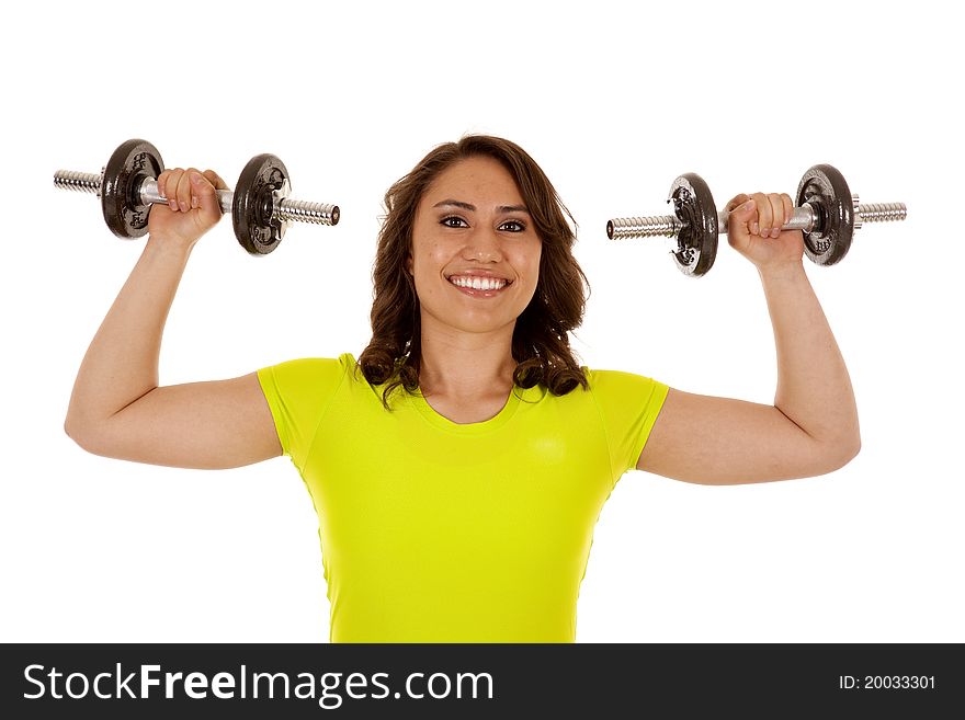 A woman lifting her weights with a huge smile on her face. A woman lifting her weights with a huge smile on her face.