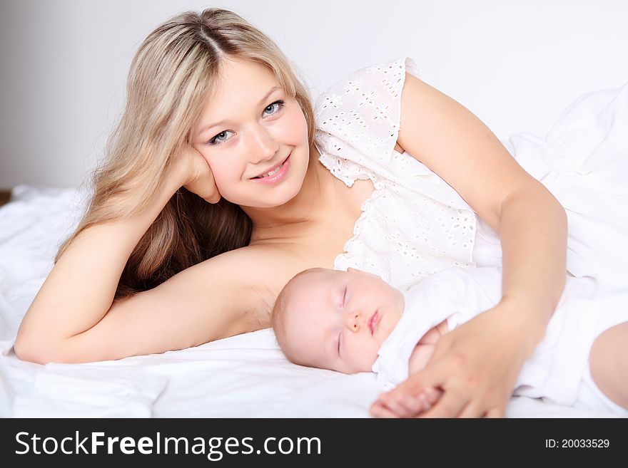 Portrait of a young mother and baby and a girl in her arms