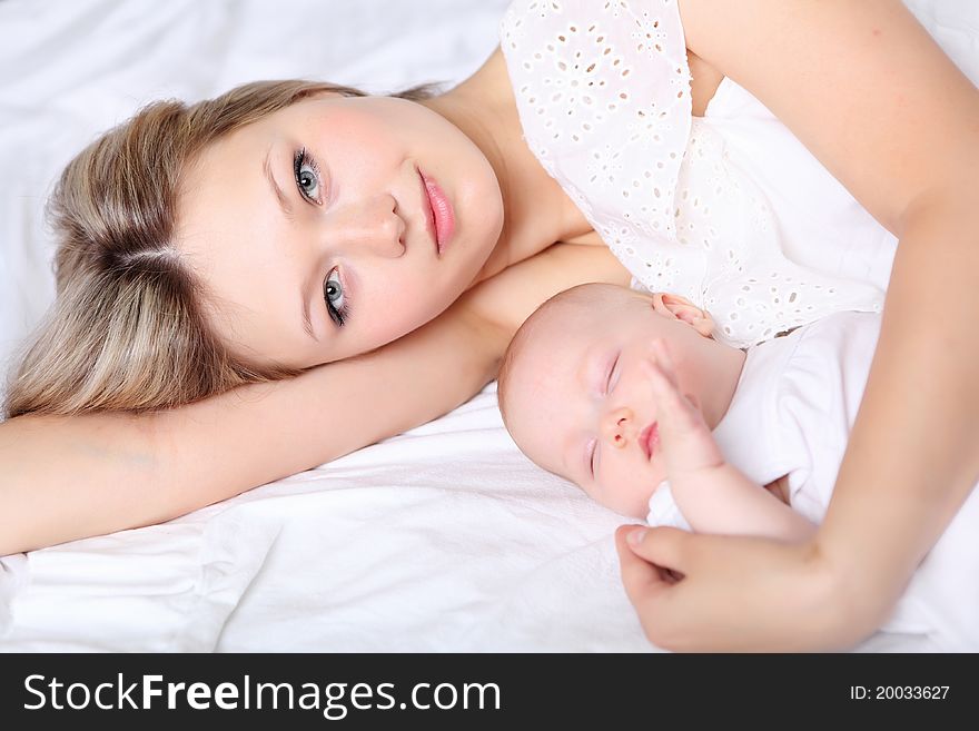 Portrait of a young mother and baby and a girl in her arms