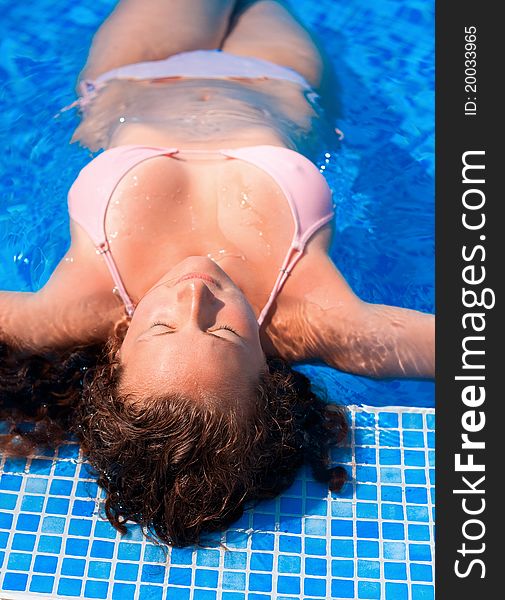 Woman Relaxing In Blue Outdoor Swimming Waterpool