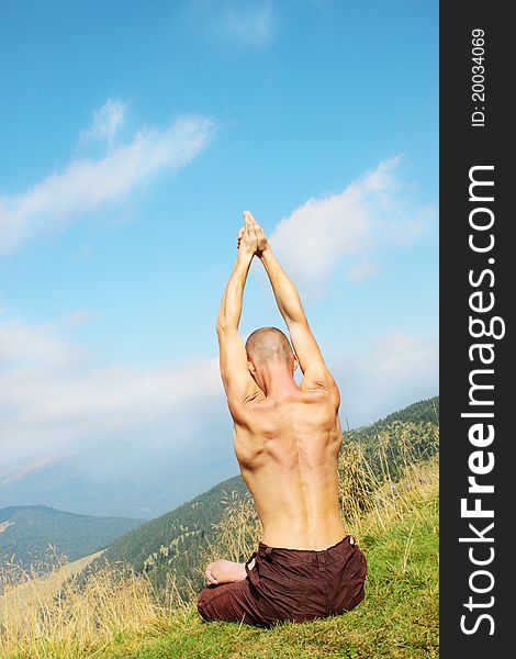 Young man is occupied yogi on the mountain. Young man is occupied yogi on the mountain