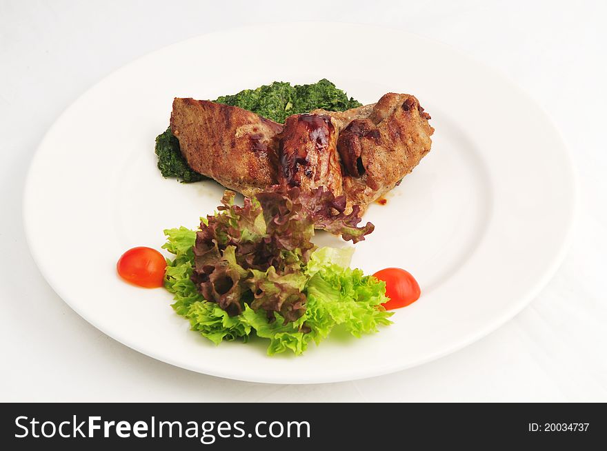 The fried meat with a garnish on a white plate