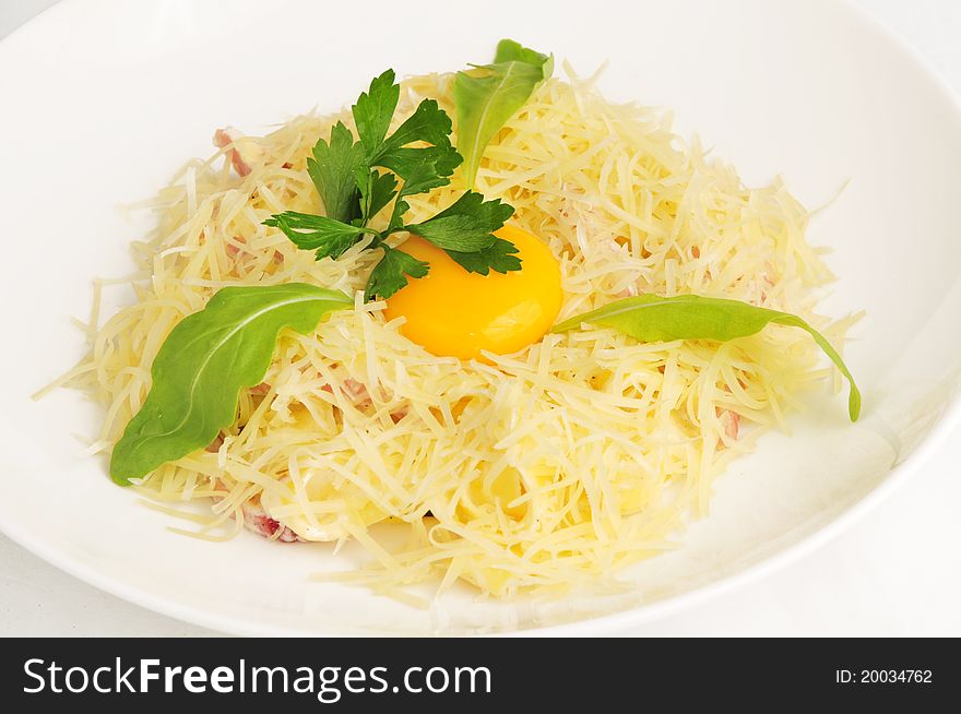 Macaroni baked with fish on a white plate