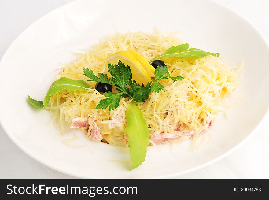 Macaroni baked with fish on a white plate