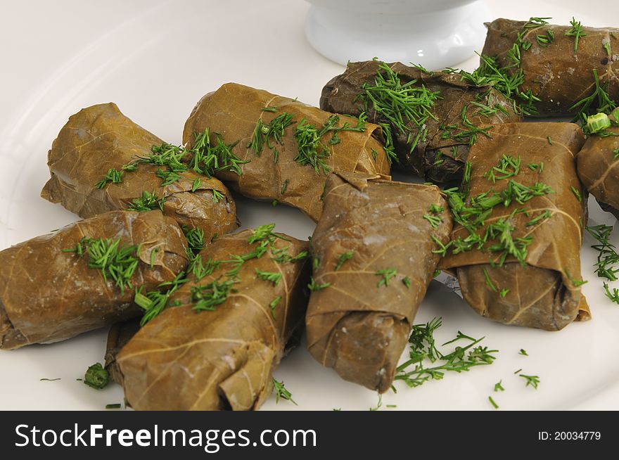 Dolma with sauce on a white plate