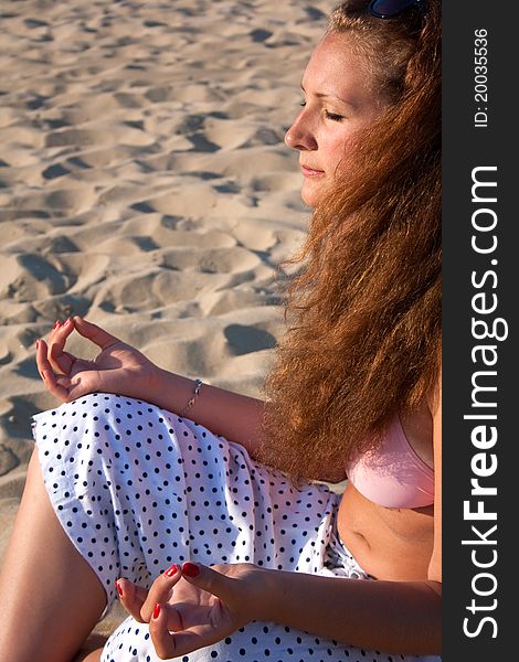 Beautiful woman meditating on beach. Beautiful woman meditating on beach