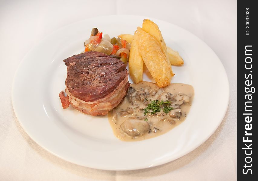 Tasty steak with potato and grilled vegetables. Tasty steak with potato and grilled vegetables