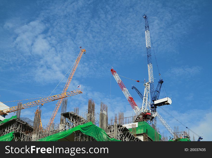 Crane and building construction on blue background