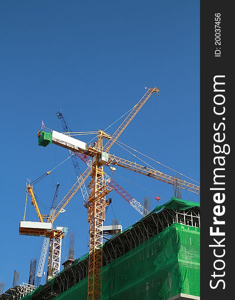 Crane and building construction on blue background