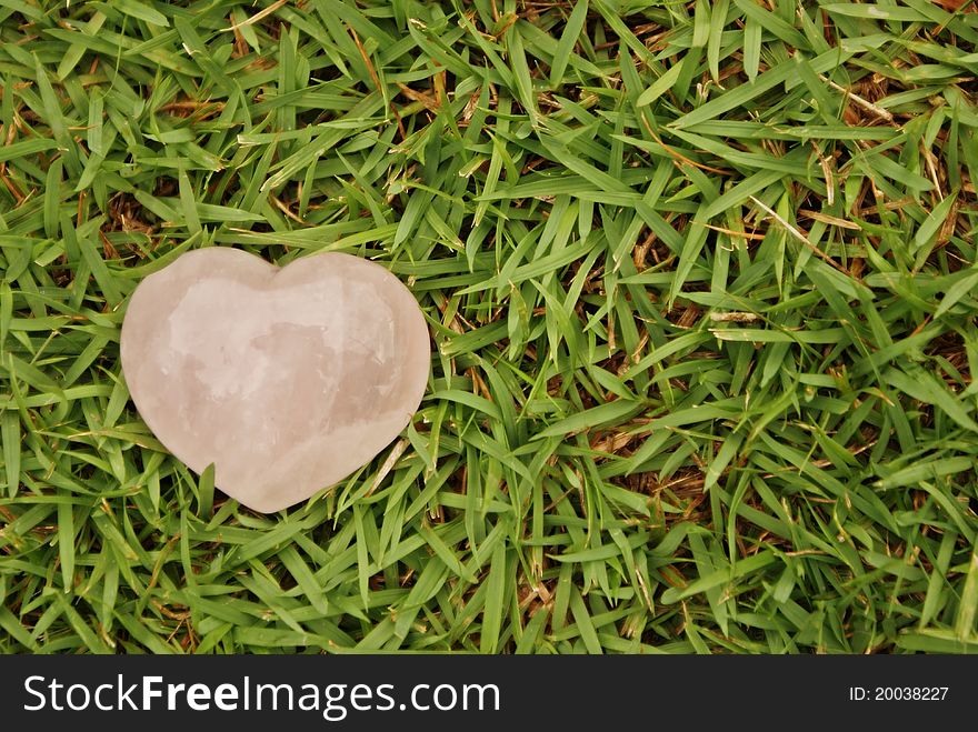 Pink heart on green grass. Pink heart on green grass