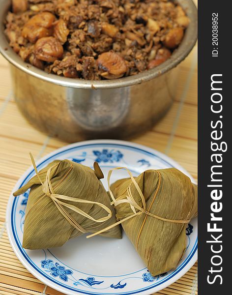 Sumptuous traditional delicacy of bamboo wrapped meat dumplings on plate. Sumptuous traditional delicacy of bamboo wrapped meat dumplings on plate.