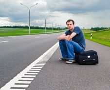 The Young Man Sits Pending On Road Stock Images The Young Man Sits Pending On Road Stock Images
