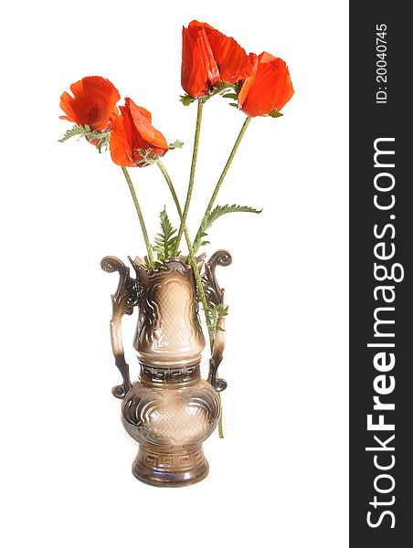 Red poppies stand in a ceramic vase. Red poppies stand in a ceramic vase