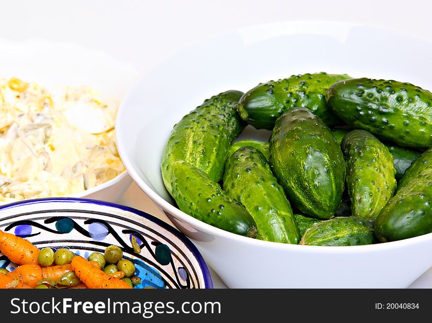 Healthy vegetarian snack: cucumbers, carrots, peas. Fresh prepared on the table.