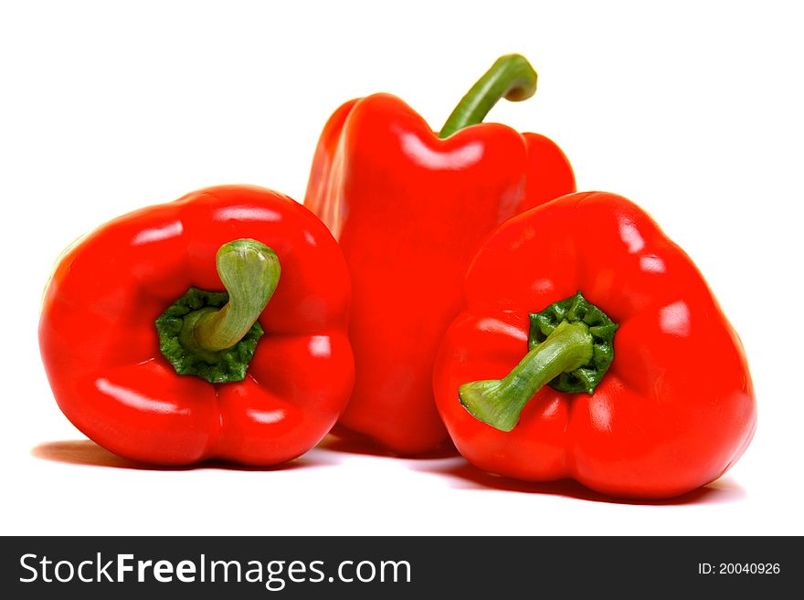 Three red peppers, isolated on white