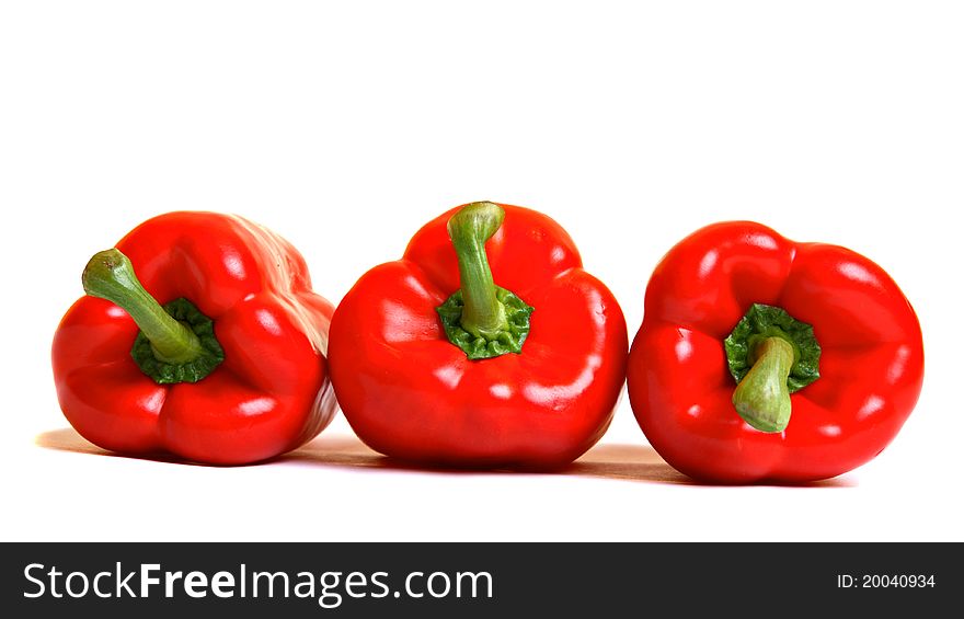 Three red peppers, isolated on white
