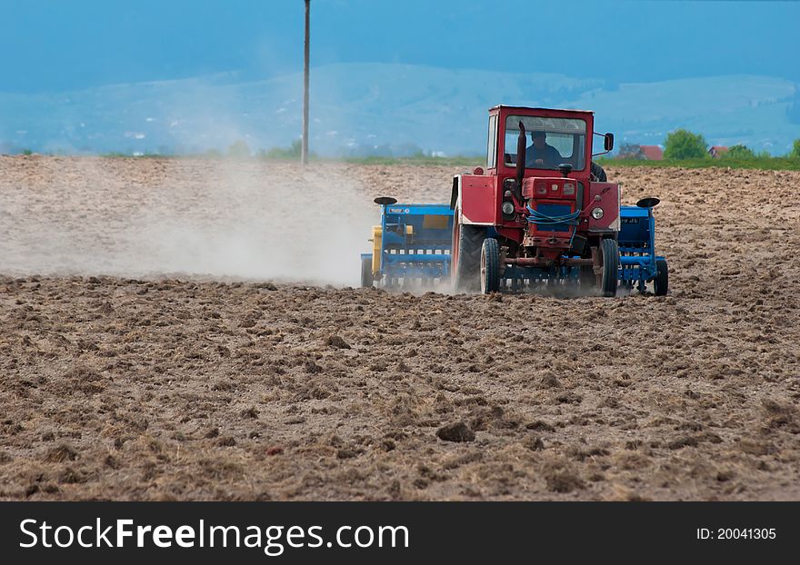Tractor ploughing field in spring. Tractor ploughing field in spring