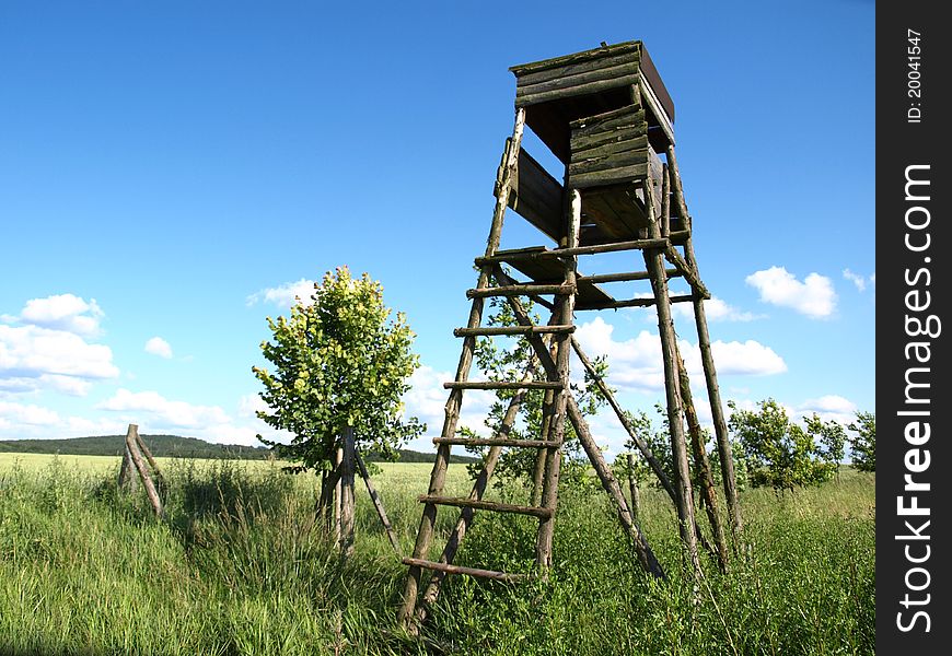 Old wooden deer stand in fields