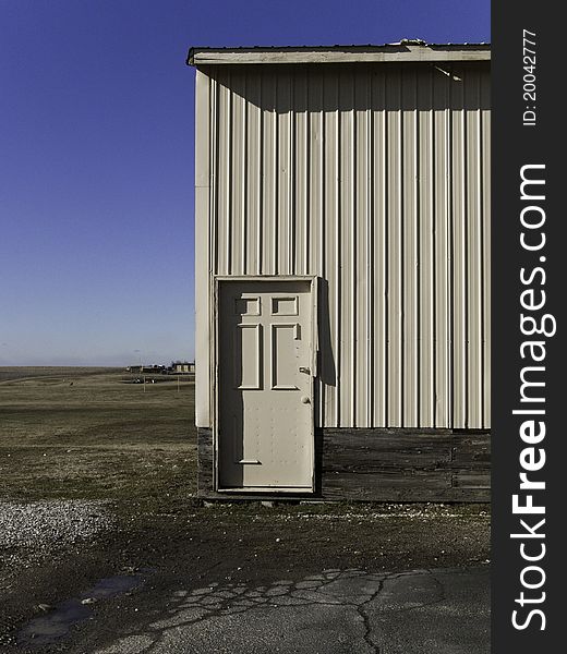 A storage building in a small country town against a bright blue sky.