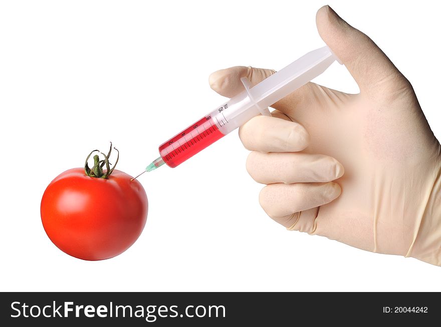 Hand with syringe make injection to tomato, isolated on white