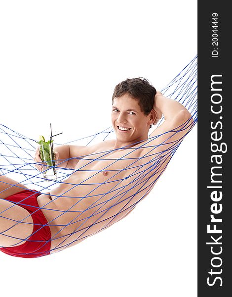 A young man with a cocktail in a hammock isolated. A young man with a cocktail in a hammock isolated