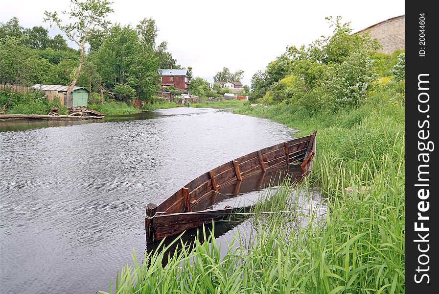 Aging drowned boat on river