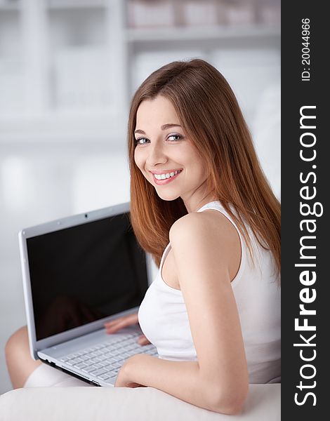 Attractive girl with a laptop at home. Attractive girl with a laptop at home